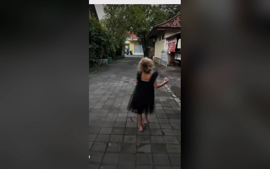 Jaya walking to a party in a black dress